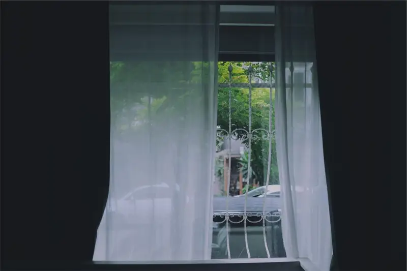 Cortina blanca semitransparente delante de una ventana